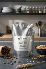 OatMlk Pro 1 Litre commercial oat milk pouch for cafés, restaurants, and home baking, showing sugar-free and lactose-free branding.