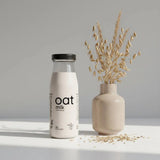 Single-serve OatMlk 200ml glass bottle, premium lactose-free and sugar-free plant-based milk mini pack.