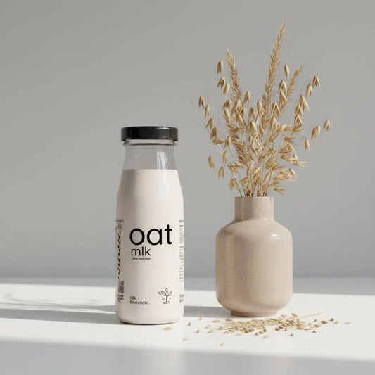 Single-serve OatMlk 200ml glass bottle, premium lactose-free and sugar-free plant-based milk mini pack.